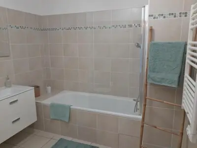 a bathroom with a bath tub and a sink at Cannes Centre-Ville, Clim, WiFi 2-4P in Cannes