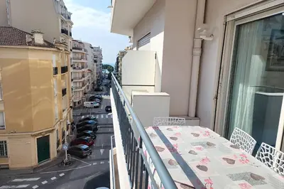 a balcony with a table and a view of a street at AHC - Versailles- 2 pièces centre ville in Cannes