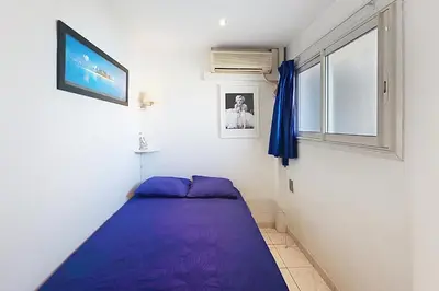 a bedroom with a purple bed and a window at AHC - Versailles- 2 pièces centre ville in Cannes