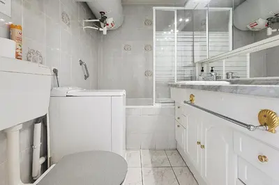 a white bathroom with a toilet and a sink at AHC - Versailles- 2 pièces centre ville in Cannes