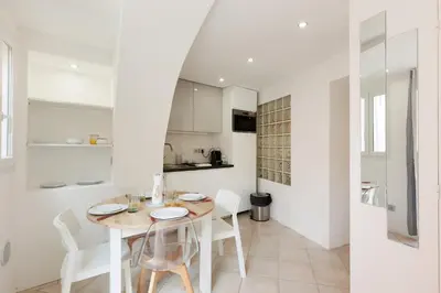 a kitchen and dining room with a table and chairs at Immogroom - Suquet - Vieux Port - Charmant T2 in Cannes