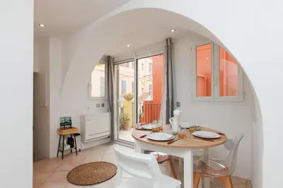 a dining room with a table and chairs at Immogroom - Suquet - Vieux Port - Charmant T2 in Cannes