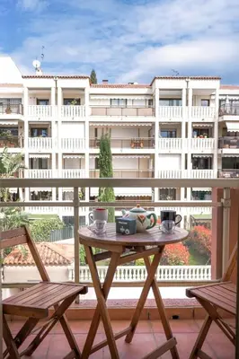 a table on top of a balcony with a building at Cannes 77 - Terrasse, spacieux, clim, paisible in Cannes