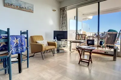 a living room with chairs and a table at Henri Camille Agency - Le Cap - 2 bedrooms Apt sea view in Cannes