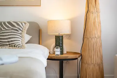 a bed with a lamp on a table next to a bed at Cannes centre derrière le Martinez in Cannes