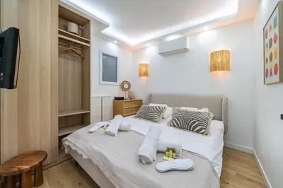a bedroom with a bed with towels on it at Cannes centre derrière le Martinez in Cannes