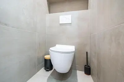 a bathroom with a white toilet in a wall at Cannes centre derrière le Martinez in Cannes