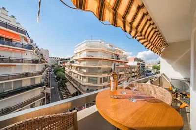 a table with a bottle of wine on top of a balcony at Cannes centre derrière le Martinez in Cannes