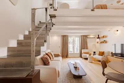 a living room with a couch and a staircase at Cannes Loft 1 bedroom - 3R in Cannes