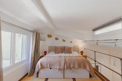 a bedroom with a bed and a large window at Cannes Loft 1 bedroom - 3R in Cannes