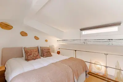 a bedroom with a white bed and a window at Cannes Loft 1 bedroom - 3R in Cannes
