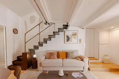 a living room with a white couch and stairs at Cannes Loft 1 bedroom - 3R in Cannes
