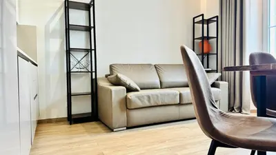a living room with a couch and a table at Cozy Croisette Retreat Cannes in Cannes