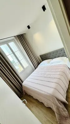a bed in a room with a window at Cozy Croisette Retreat Cannes in Cannes