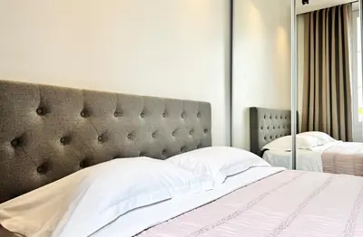 a bedroom with a large bed and a large mirror at Cozy Croisette Retreat Cannes in Cannes