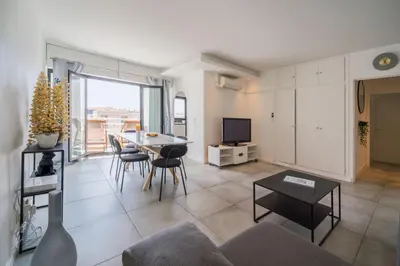 a living room with a couch and a table at Évasion Pointe Croisette, vue mer, plage à une minute in Cannes