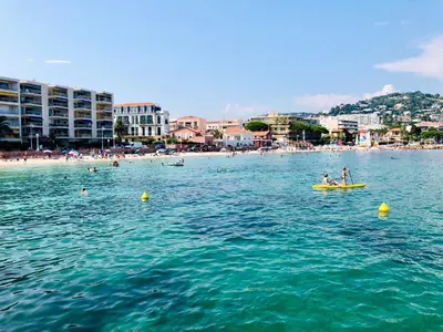 a group of people in a yellow boat in the water at Évasion Pointe Croisette, vue mer, plage à une minute in Cannes