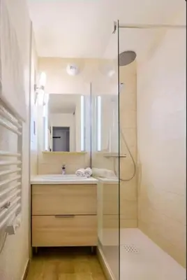 a bathroom with a glass shower and a sink at Villa Livia - Citea - Groupe Pierre & Vacances Tourisme Piscine et mer à proximité - Résidence rénovée in Cannes