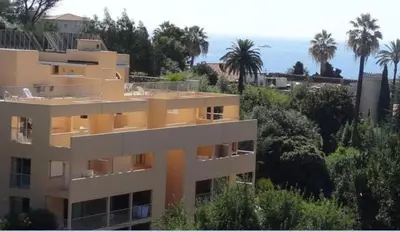 a view of a building with the ocean in the background at Villa Livia - Citea - Groupe Pierre & Vacances Tourisme Piscine et mer à proximité - Résidence rénovée in Cannes