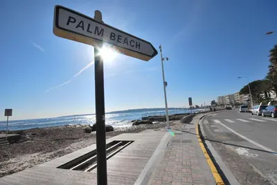 a street sign on the side of a beach at One bedroom apartment Palm Beach in Cannes