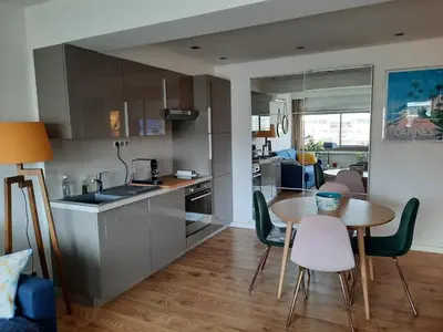 a kitchen and dining room with a table and chairs at One bedroom apartment Palm Beach in Cannes