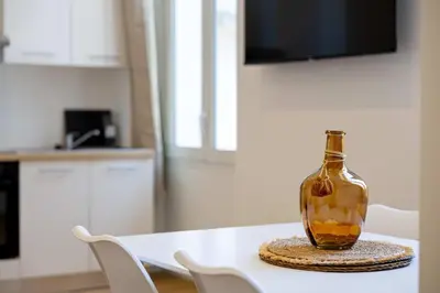 a glass bottle sitting on a table in a kitchen at LE COSY un havre de paix près de la Croisette in Cannes
