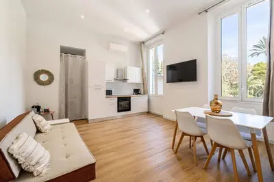 a living room with a couch and a table at LE COSY un havre de paix près de la Croisette in Cannes