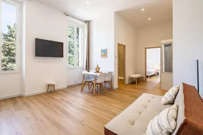 a living room with a couch and a table at LE COSY un havre de paix près de la Croisette in Cannes