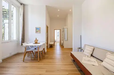 a living room with a couch and a table at LE COSY un havre de paix près de la Croisette in Cannes
