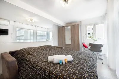 a bedroom with a bed with two towels on it at Charmant Studio - Calme - Croisette & Plage à 7 min in Cannes
