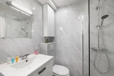 a bathroom with a shower and a toilet and a sink at Charmant Studio - Calme - Croisette & Plage à 7 min in Cannes