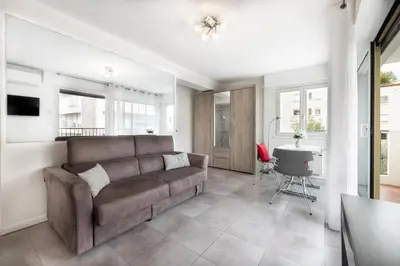 a living room with a couch and a table at Charmant Studio - Calme - Croisette & Plage à 7 min in Cannes