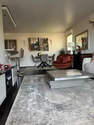 a living room with a couch and a table at Apartment in park with pool in Cannes