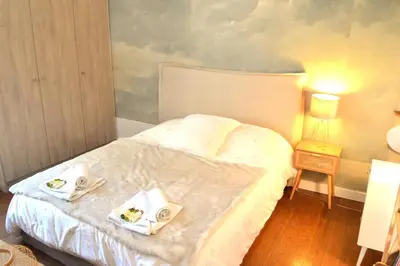 a bedroom with a bed with two towels on it at Charming Apartment Cannes City Center and Beaches in Cannes