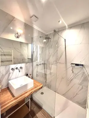 a white bathroom with a sink and a shower at Charming Apartment Cannes City Center and Beaches in Cannes