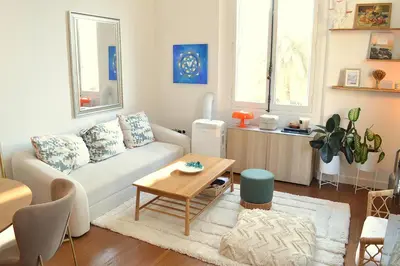 a living room with a couch and a table at Charming Apartment Cannes City Center and Beaches in Cannes