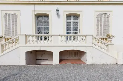 a white building with a staircase on it at Palais Beaulieu Magnifique 3p 2 chambres in Cannes