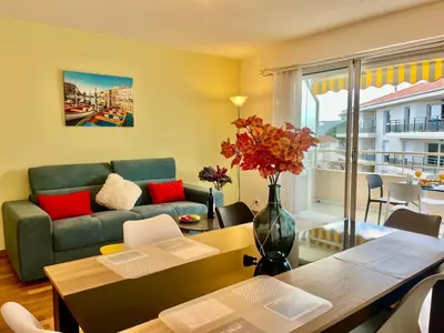 a living room with a couch and a table at Le Lys d'Or in Cannes
