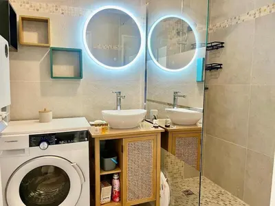a bathroom with a washing machine and two sinks at Le Lys d'Or in Cannes