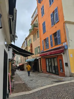 a person walking down a street next to buildings at Cannes - Centre- Film Festival in Cannes
