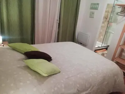 a white bed with two green pillows on it at Cannes - Centre- Film Festival in Cannes