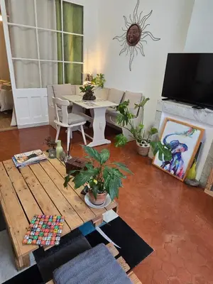 a living room with a table and a couch and a table and a tv at Cannes - Centre- Film Festival in Cannes