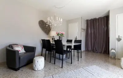 a dining room with a table and chairs and a chandelier at Work or vacation - lovely apartment - central in Cannes