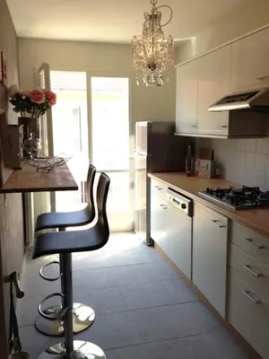 a kitchen with a bar stool in the middle of it at Work or vacation - lovely apartment - central in Cannes