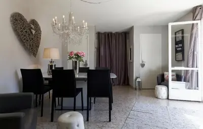 a dining room with a table with chairs and a chandelier at Work or vacation - lovely apartment - central in Cannes