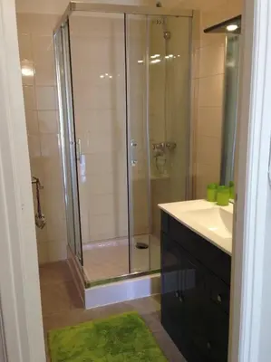 a bathroom with a glass shower with a sink and a shower at Work or vacation - lovely apartment - central in Cannes