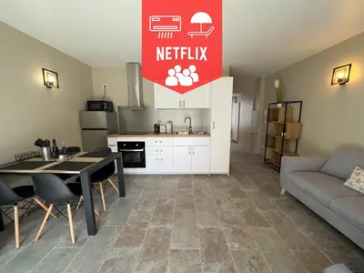 a kitchen and living room with a table and a couch at COSY CASTILLE - Proche de la CROISETTE in Cannes