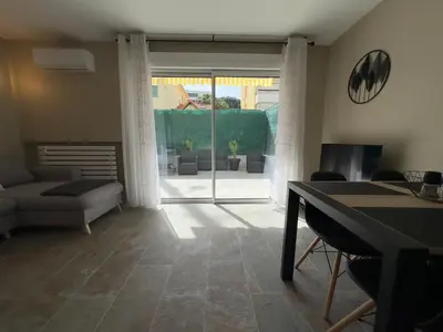 a living room with a couch and a table at COSY CASTILLE - Proche de la CROISETTE in Cannes
