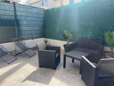 a patio with chairs and a table and a fence at COSY CASTILLE - Proche de la CROISETTE in Cannes