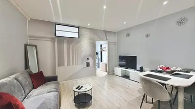 a living room with a couch and a table at Cannes 1-Bedroom Apartment - 15M in Cannes